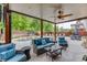 Inviting backyard patio with ample seating, a ceiling fan, and views of the pool and landscaped yard at 3939 Soft Wind Ter, Buford, GA 30518