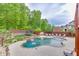 Serene backyard featuring a sparkling pool, trampoline, and lush greenery, perfect for outdoor fun and relaxation at 3939 Soft Wind Ter, Buford, GA 30518