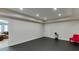 Spacious basement area with black flooring and ample lighting, perfect for recreation or a home gym at 3939 Soft Wind Ter, Buford, GA 30518