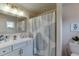 Bright bathroom featuring a vanity, mirror, shower curtain, and toilet at 3939 Soft Wind Ter, Buford, GA 30518