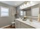 Bright bathroom featuring dual sinks, a large mirror, and neutral fixtures, blending style and functionality at 3939 Soft Wind Ter, Buford, GA 30518