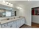 Spacious bathroom with granite countertops, dual sinks, a large mirror, and a walk-in closet perfect for storage at 3939 Soft Wind Ter, Buford, GA 30518