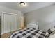 Bright bedroom features hardwood floors, natural light, checkered bedding, dresser, and closet at 3939 Soft Wind Ter, Buford, GA 30518