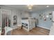 Bedroom showcasing a bunk bed, white chair, wood floors, and a decorative mirror at 3939 Soft Wind Ter, Buford, GA 30518