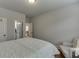 Comfortable bedroom featuring neutral walls, hardwood floors, chair, and doorway views into other rooms at 3939 Soft Wind Ter, Buford, GA 30518
