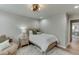 Bright, airy bedroom with wood floors, a plush chair, and soft lighting, creating a cozy and inviting space at 3939 Soft Wind Ter, Buford, GA 30518
