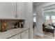 Butlers pantry featuring white cabinets, stainless steel appliances and beautiful granite countertops at 3939 Soft Wind Ter, Buford, GA 30518