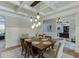 Charming dining area with a modern chandelier and a view into the nearby home office at 3939 Soft Wind Ter, Buford, GA 30518