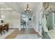 Elegant foyer with hardwood floors, coffered ceiling, wainscoting, and view of the dining and living spaces at 3939 Soft Wind Ter, Buford, GA 30518