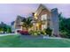 Charming stone and brick home with a well-manicured lawn and beautiful landscaping around the front yard at 3939 Soft Wind Ter, Buford, GA 30518