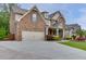 Two-story home featuring a manicured lawn, spacious driveway, and a beautiful stone and siding exterior at 3939 Soft Wind Ter, Buford, GA 30518