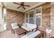 Inviting front porch with stone accents, comfortable seating, and charming decorative touches at 3939 Soft Wind Ter, Buford, GA 30518