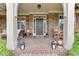 Charming front porch with stone pillars, cozy seating, and decorative lanterns, creating a welcoming entrance at 3939 Soft Wind Ter, Buford, GA 30518