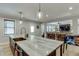 Open concept kitchen with island seating, exposed brick wall, stainless steel appliances and island sink at 3939 Soft Wind Ter, Buford, GA 30518