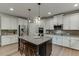 A modern kitchen featuring a large island, white cabinets and stainless steel appliances at 3939 Soft Wind Ter, Buford, GA 30518