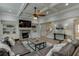 Cozy living room with a stone fireplace, built-in shelves and coffered ceiling at 3939 Soft Wind Ter, Buford, GA 30518