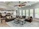Open-concept living room with hardwood floors, a ceiling fan, and lots of natural light at 3939 Soft Wind Ter, Buford, GA 30518