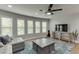 Comfortable living room with a gray sectional sofa and a large wall-mounted television at 3939 Soft Wind Ter, Buford, GA 30518