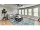 Spacious living room with a gray couch, coffee table, and plenty of natural light at 3939 Soft Wind Ter, Buford, GA 30518