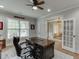 Inviting office with an executive desk, ceiling fan, and lots of natural light from the nearby window at 3939 Soft Wind Ter, Buford, GA 30518