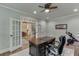 Comfortable office space with French doors, hardwood floors, and a large desk and ergonomic chair at 3939 Soft Wind Ter, Buford, GA 30518