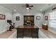 Well-appointed home office featuring hardwood floors, ceiling fan, and a large, solid wood executive desk at 3939 Soft Wind Ter, Buford, GA 30518