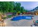 Aerial view of backyard oasis with pool, sport court, fire pit, and manicured landscaping at 3939 Soft Wind Ter, Buford, GA 30518
