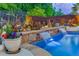 Backyard pool featuring waterfall features, a garden area, and comfortable Adirondack seating at 3939 Soft Wind Ter, Buford, GA 30518