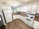 Efficient kitchen with white cabinets, appliances, and a practical layout, perfect for everyday meals at 5846 Par Four Ct, Lithonia, GA 30038