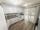 Functional kitchen with white appliances and ample counter space, ready for cooking and entertaining at 5846 Par Four Ct, Lithonia, GA 30038