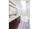 Bright bathroom with a double sink vanity, a large mirror, a skylight, and a tub-shower combination at 1451 Brays Mill Trce, Lawrenceville, GA 30044