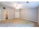 Large bedroom with a ceiling fan, and adjoined by the walk-in closet and a couple of double-door closets at 1451 Brays Mill Trce, Lawrenceville, GA 30044