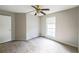 Neutral bedroom with ceiling fan, window, and carpeted floor at 1451 Brays Mill Trce, Lawrenceville, GA 30044