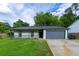 Charming single-story home with a well-maintained lawn, a cozy porch, and attached garage at 1451 Brays Mill Trce, Lawrenceville, GA 30044