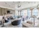 Covered balcony with an outdoor kitchen, fireplace, and comfortable seating at 976 Memorial Se Walk, Atlanta, GA 30316