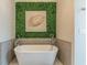 Bathroom with a modern soaking tub and a decorative wall accent at 976 Memorial Se Walk, Atlanta, GA 30316