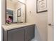 Bathroom vanity featuring grey cabinets, modern faucet, marble countertops, and decorative artwork at 976 Memorial Se Walk, Atlanta, GA 30316