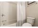 Clean white bathroom with tub, tile surround, and toilet at 976 Memorial Se Walk, Atlanta, GA 30316