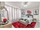 Bedroom features a plush red rug and a statement mirror, alongside tree-themed wall art at 976 Memorial Se Walk, Atlanta, GA 30316