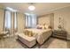 Bedroom with a decorative headboard, chandelier, and upholstered bench at 976 Memorial Se Walk, Atlanta, GA 30316