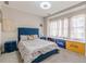 This is a bedroom with a blue bed, window seating, and fun colorful decorations at 976 Memorial Se Walk, Atlanta, GA 30316