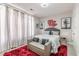 Bedroom features a plush red rug and a statement mirror, alongside tree-themed wall art at 976 Memorial Se Walk, Atlanta, GA 30316