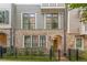 Beautiful townhome featuring brick and siding accents with an arched entryway and black wrought iron fence at 976 Memorial Se Walk, Atlanta, GA 30316