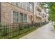 Attractive townhome exteriors featuring brick accents, large windows, and landscaping along a sidewalk at 976 Memorial Se Walk, Atlanta, GA 30316