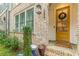 Charming entryway with a bright yellow door, brick facade, and well-manicured landscaping at 976 Memorial Se Walk, Atlanta, GA 30316