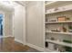 Bright hallway featuring hardwood floors, white trim, and built in shelving with decorative accents at 976 Memorial Se Walk, Atlanta, GA 30316