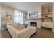 Bright living room with a fireplace, TV, modern decor, and comfortable seating for relaxation and entertainment at 976 Memorial Se Walk, Atlanta, GA 30316