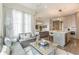 Elegant living room featuring modern decor, plush seating, and an open layout leading to a sleek kitchen at 976 Memorial Se Walk, Atlanta, GA 30316