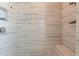 Modern shower with horizontal marble-look tiling and a built in bench at 976 Memorial Se Walk, Atlanta, GA 30316