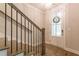 Elegant staircase with hardwood treads, a crystal chandelier, and a glass-paneled entry door at 976 Memorial Se Walk, Atlanta, GA 30316